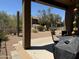 View of backyard with patio furniture, desert landscaping, and mature trees at 7361 E Rugged Ironwood Rd, Gold Canyon, AZ 85118