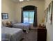 Cozy bedroom featuring twin beds, gray curtains, and view of outdoor landscape at 7361 E Rugged Ironwood Rd, Gold Canyon, AZ 85118