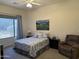 Comfortable bedroom with a large window, a queen bed, and a cozy recliner at 7361 E Rugged Ironwood Rd, Gold Canyon, AZ 85118