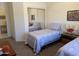 Bedroom featuring twin beds, carpet, and a mirrored closet with mirrored sliding doors at 7361 E Rugged Ironwood Rd, Gold Canyon, AZ 85118