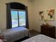 Comfortable bedroom with twin beds, large window, and desert landscape view at 7361 E Rugged Ironwood Rd, Gold Canyon, AZ 85118