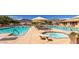 Community swimming pools and hot tubs with mountain views and lounge seating at 7361 E Rugged Ironwood Rd, Gold Canyon, AZ 85118