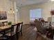 Dining area featuring modern light fixture and a view of the living room at 7361 E Rugged Ironwood Rd, Gold Canyon, AZ 85118