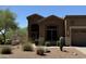 Exterior of home featuring well-maintained landscaping and an attached garage at 7361 E Rugged Ironwood Rd, Gold Canyon, AZ 85118