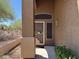 Inviting front door with a security screen door in a desert landscape on a sunny day at 7361 E Rugged Ironwood Rd, Gold Canyon, AZ 85118