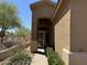 Front entrance featuring desert landscaping and a partial view of the lake at 7361 E Rugged Ironwood Rd, Gold Canyon, AZ 85118