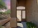 Covered front porch with decorative columns, security door and desert landscaping at 7361 E Rugged Ironwood Rd, Gold Canyon, AZ 85118