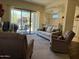 Living room showcases a sliding door leading to an outdoor patio with ceiling fan at 7361 E Rugged Ironwood Rd, Gold Canyon, AZ 85118