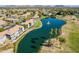 An aerial view showcases condos surrounding a lake with a fountain, lush greenery, and tall palms at 7401 W Arrowhead Clubhouse Dr # 2045, Glendale, AZ 85308