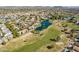 Expansive aerial shot of condos, a pond with fountain, golf course, and distant mountain views at 7401 W Arrowhead Clubhouse Dr # 2045, Glendale, AZ 85308