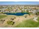 A wide aerial view of condos near a pond with a fountain, set alongside a well-maintained golf course at 7401 W Arrowhead Clubhouse Dr # 2045, Glendale, AZ 85308