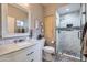 Bathroom featuring a marble vanity, framed mirror, and walk-in shower with glass door at 7401 W Arrowhead Clubhouse Dr # 2045, Glendale, AZ 85308