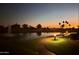 Scenic community view of a pond and sidewalk, enhanced by landscape lighting at sunset, providing a tranquil atmosphere at 7401 W Arrowhead Clubhouse Dr # 2045, Glendale, AZ 85308