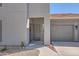 Exterior view of condo entrance and attached single car garage featuring landscaped yard at 7401 W Arrowhead Clubhouse Dr # 2045, Glendale, AZ 85308