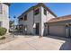 Two-story condo features neutral stucco, tile roof, two car garage, and well-manicured landscaping at 7401 W Arrowhead Clubhouse Dr # 2045, Glendale, AZ 85308