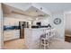 Modern kitchen features white cabinetry, stainless steel appliances, breakfast bar and stylish tile backsplash at 7401 W Arrowhead Clubhouse Dr # 2045, Glendale, AZ 85308