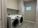 Dedicated laundry room with tile floors, shelving and space for full-sized washer and dryer at 7401 W Arrowhead Clubhouse Dr # 2045, Glendale, AZ 85308