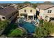 Backyard aerial showcasing a sparkling pool, spa, and lush landscaping at 7567 W Andrea Dr, Peoria, AZ 85383