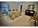 Cozy bedroom with carpet, a dresser, and chair providing a comfortable living space at 7567 W Andrea Dr, Peoria, AZ 85383