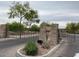 Elegant community entrance gate with decorative stone pillars and landscaping, providing security and curb appeal at 7567 W Andrea Dr, Peoria, AZ 85383