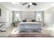 Sun-filled main bedroom featuring modern fixtures, hardwood floors, and neutral colors at 7567 W Andrea Dr, Peoria, AZ 85383