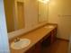 Bathroom featuring a double sink vanity with laminate countertops and framed mirrors at 8371 W Santa Cruz Blvd, Arizona City, AZ 85123