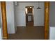 Spacious living room with tile flooring and exposed wood support beams leading to the kitchen with white appliances at 8371 W Santa Cruz Blvd, Arizona City, AZ 85123