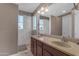 Bathroom featuring double sinks, granite countertops, and a window for natural light at 857 S Osborn Ln, Gilbert, AZ 85296