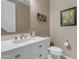 Well-lit bathroom with white marble countertop and white vanity with brush nickel fixtures at 857 S Osborn Ln, Gilbert, AZ 85296