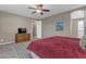 A bedroom features a ceiling fan, natural light and warm-toned walls at 857 S Osborn Ln, Gilbert, AZ 85296