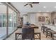 Bright dining area with large sliding doors, tile flooring, and a dark wood dining table at 857 S Osborn Ln, Gilbert, AZ 85296