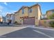 Two-story home with a brown garage door and neutral stucco exterior; well-kept landscaping at 857 S Osborn Ln, Gilbert, AZ 85296