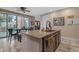 Kitchen island with granite countertops, stainless steel faucet and dining table with chairs at 857 S Osborn Ln, Gilbert, AZ 85296