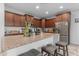 Modern kitchen with stainless steel appliances, granite counters, subway tile backsplash and breakfast bar seating at 857 S Osborn Ln, Gilbert, AZ 85296