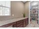 Granite countertop with base cabinets and view into a pantry filled with shelving at 857 S Osborn Ln, Gilbert, AZ 85296