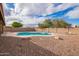 Backyard boasts a private pool, a low-maintenance gravel landscape, and a secure block fence for added enjoyment at 8738 W Mountain View Rd, Peoria, AZ 85345