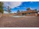 Backyard with a sparkling pool, a gravel landscape, and a private block fence, perfect for outdoor living at 8738 W Mountain View Rd, Peoria, AZ 85345