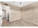 Neutral bedroom boasts carpet flooring, a ceiling fan, and an entry door, creating a comfortable atmosphere at 8738 W Mountain View Rd, Peoria, AZ 85345