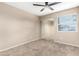 Neutral bedroom features carpet flooring, a ceiling fan and a mirrored closet for ample storage space at 8738 W Mountain View Rd, Peoria, AZ 85345