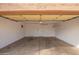 Spacious garage features a concrete floor, storage shelves, and two doors for easy access and organization at 8738 W Mountain View Rd, Peoria, AZ 85345