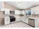 Well-lit kitchen featuring white cabinets, stainless steel appliances, and a modern design at 8738 W Mountain View Rd, Peoria, AZ 85345