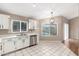 Bright kitchen with stainless steel appliances and white cabinets, overlooking the pool at 8738 W Mountain View Rd, Peoria, AZ 85345