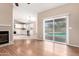 Bright living room with fireplace, wood floors, and sliding glass doors to the pool area at 8738 W Mountain View Rd, Peoria, AZ 85345