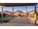 Beautiful backyard with a paved patio, palm trees, and play set at 1010 E Vernoa St, San Tan Valley, AZ 85140