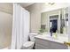 Bright bathroom featuring a shower with a curtain, toilet, and vanity at 1010 E Vernoa St, San Tan Valley, AZ 85140