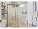 Bathroom showcasing the shower stall, glass doors, and wooden shelving at 1010 E Vernoa St, San Tan Valley, AZ 85140