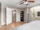 Neutral bedroom featuring tile floors, a ceiling fan, and an attached bathroom at 1010 E Vernoa St, San Tan Valley, AZ 85140