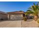 Charming single-story home featuring a two-car garage, low maintenance landscaping, and a red tile roof at 1010 E Vernoa St, San Tan Valley, AZ 85140