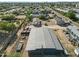 Wide aerial shot showcasing property, surrounding neighborhood, and long metal building at 10243 E Illini St, Mesa, AZ 85208