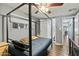 Bedroom featuring a metal bed frame, ceiling fan, and dark wood floors at 10243 E Illini St, Mesa, AZ 85208